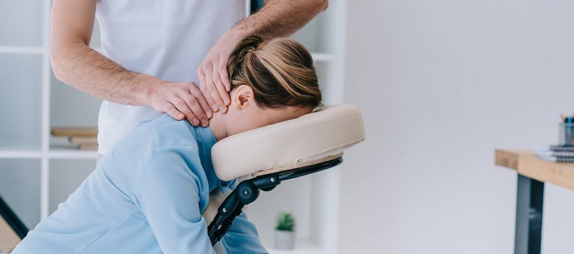 A woman is getting a neck massage