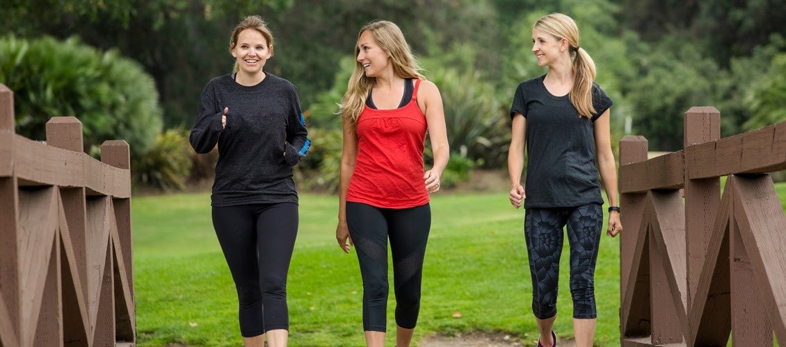 3 woman are walking. 