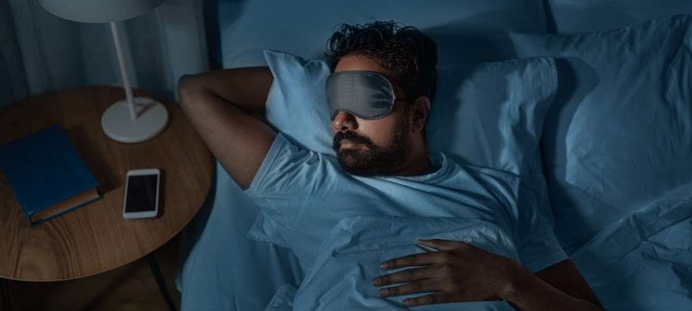 Man sleeping with eye covering