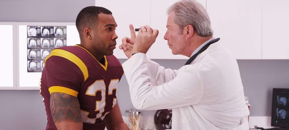 A doctor examining an athlete's eyes