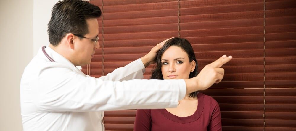 A doctor conducts an eye exam with a patient.