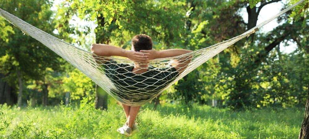 Man relaxing in a hammock.