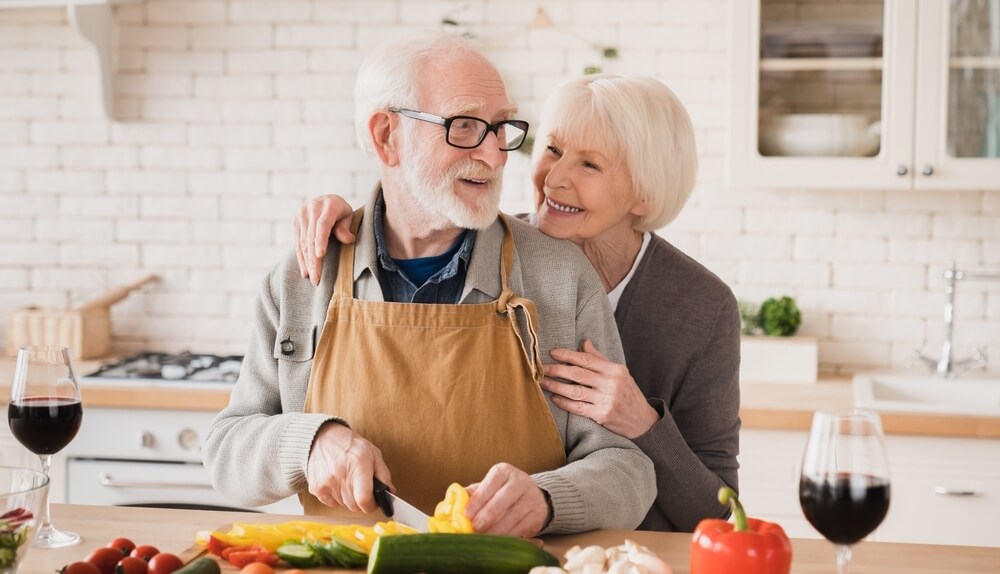 Senior couple cooking dinner in the kitch