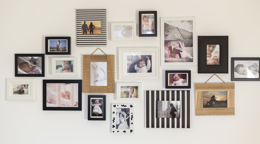 Family photographs on the living room wall of a home