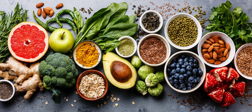 A table filled with healthy food (fruits, vegetables, nuts, etc.)