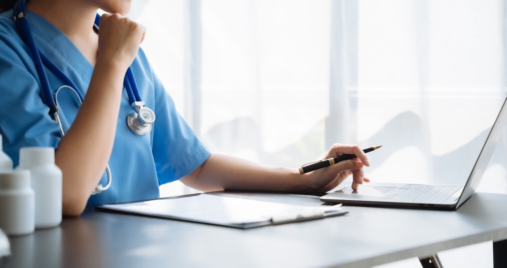 A doctor working at her desk on her computer