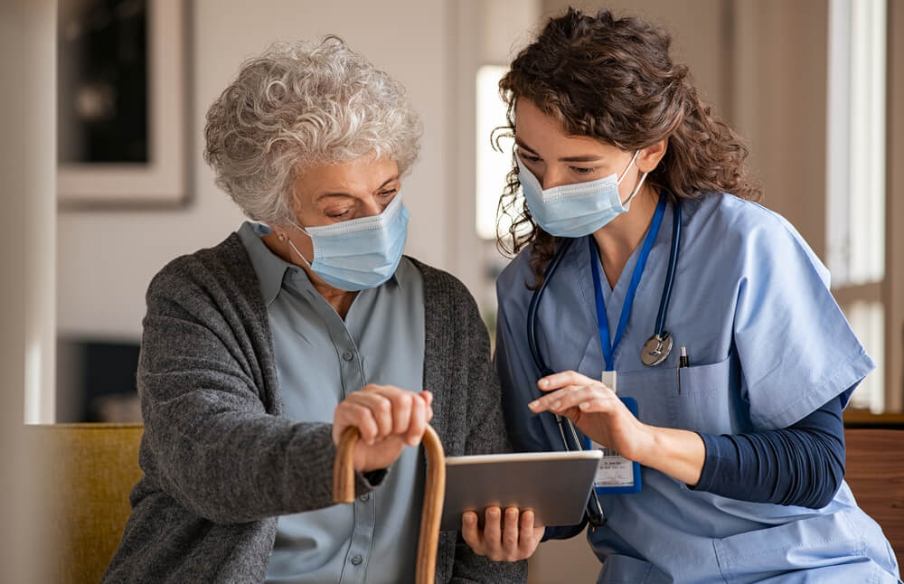 Doctor and senior patient overlooking medical records