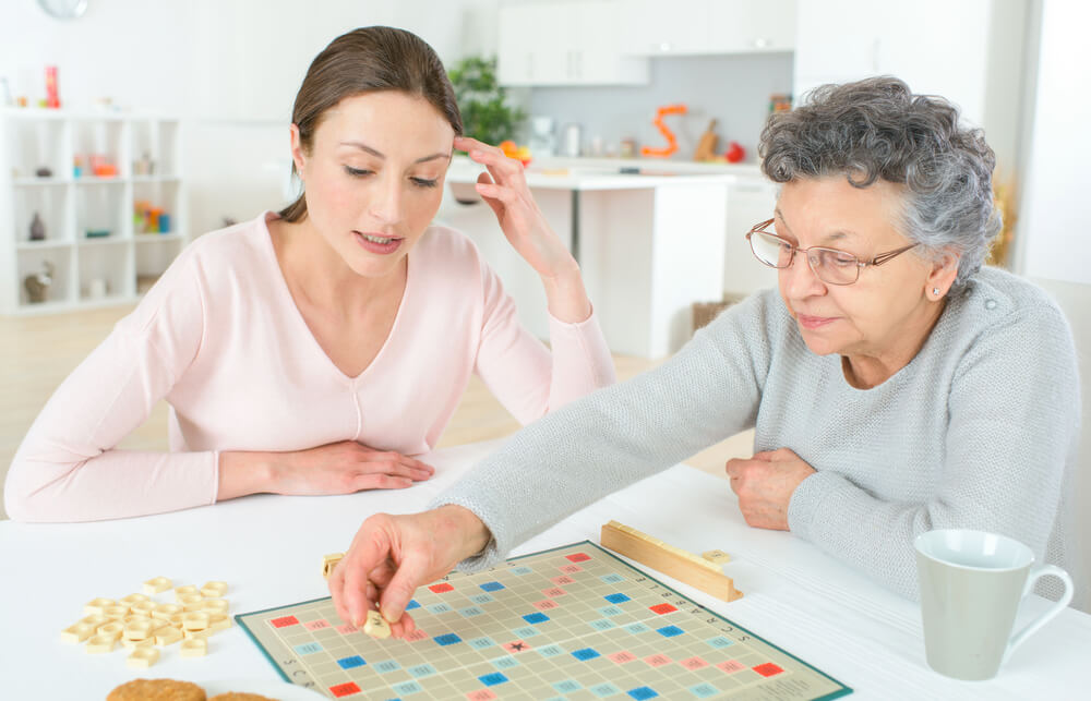 Grandma and granddaughter playing Scrabble