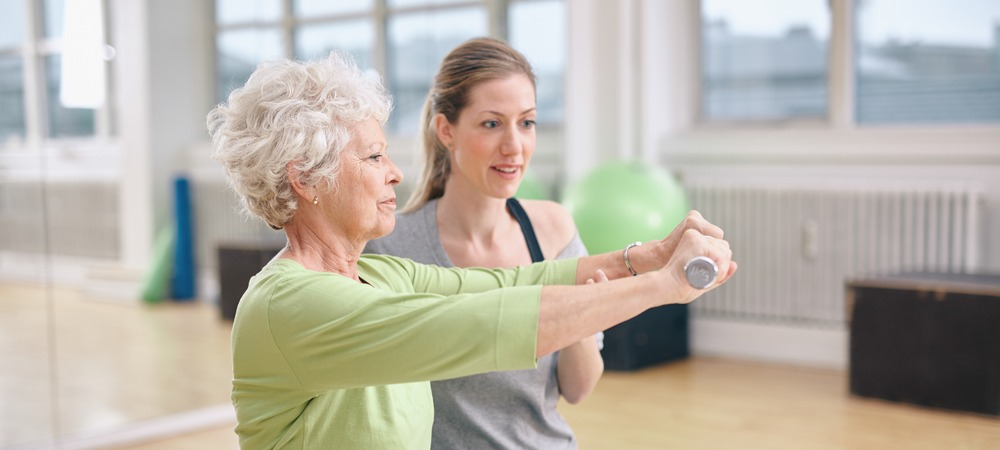 Physical therapist working with elderly woman. 