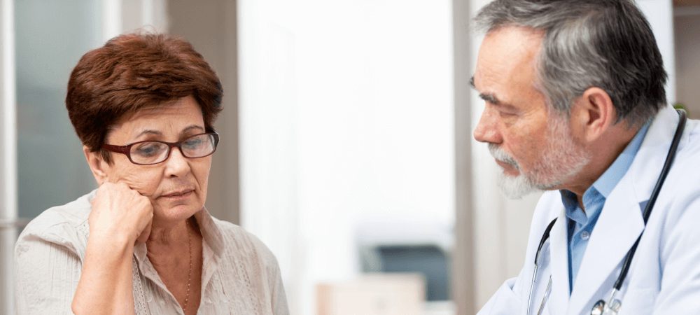 Elderly woman meeting with doctor. 