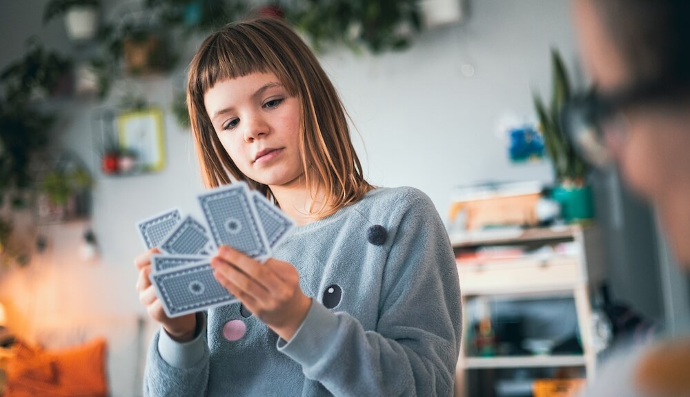 Girl playing cards at home