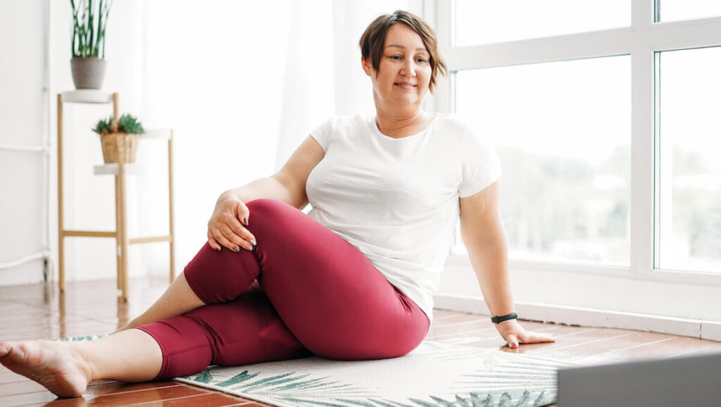 Brunette woman doing yoga at home